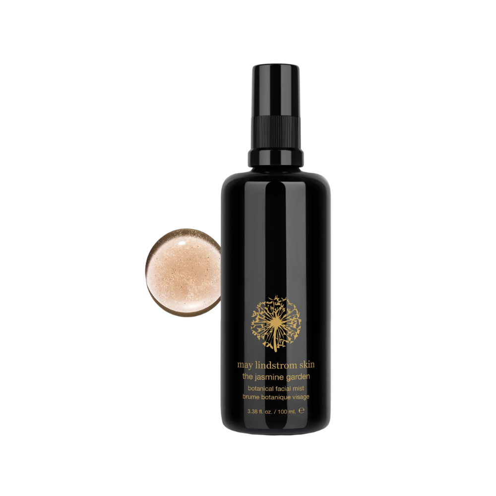 Black bottle of May Lindstrom The Jasmine Garden Facial Mist with a droplet of the mist on the left