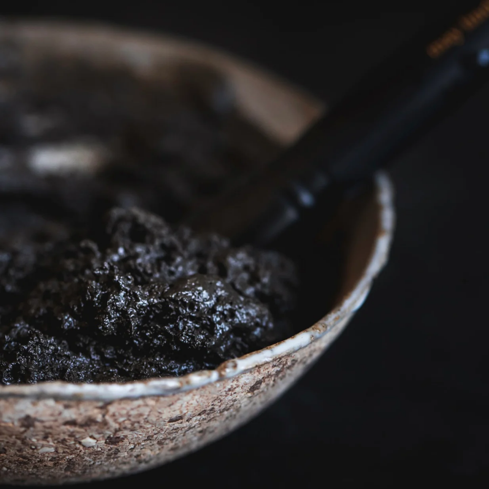 May Lindstrom The Problem Solver mixed with water showing a mud-like texture in a stone bowl