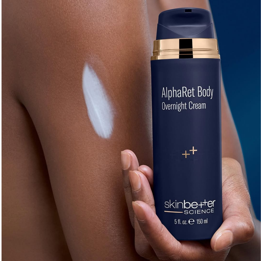 SkinBetter AlphaRet Body Overnight Cream bottle held against skin with visible cream application