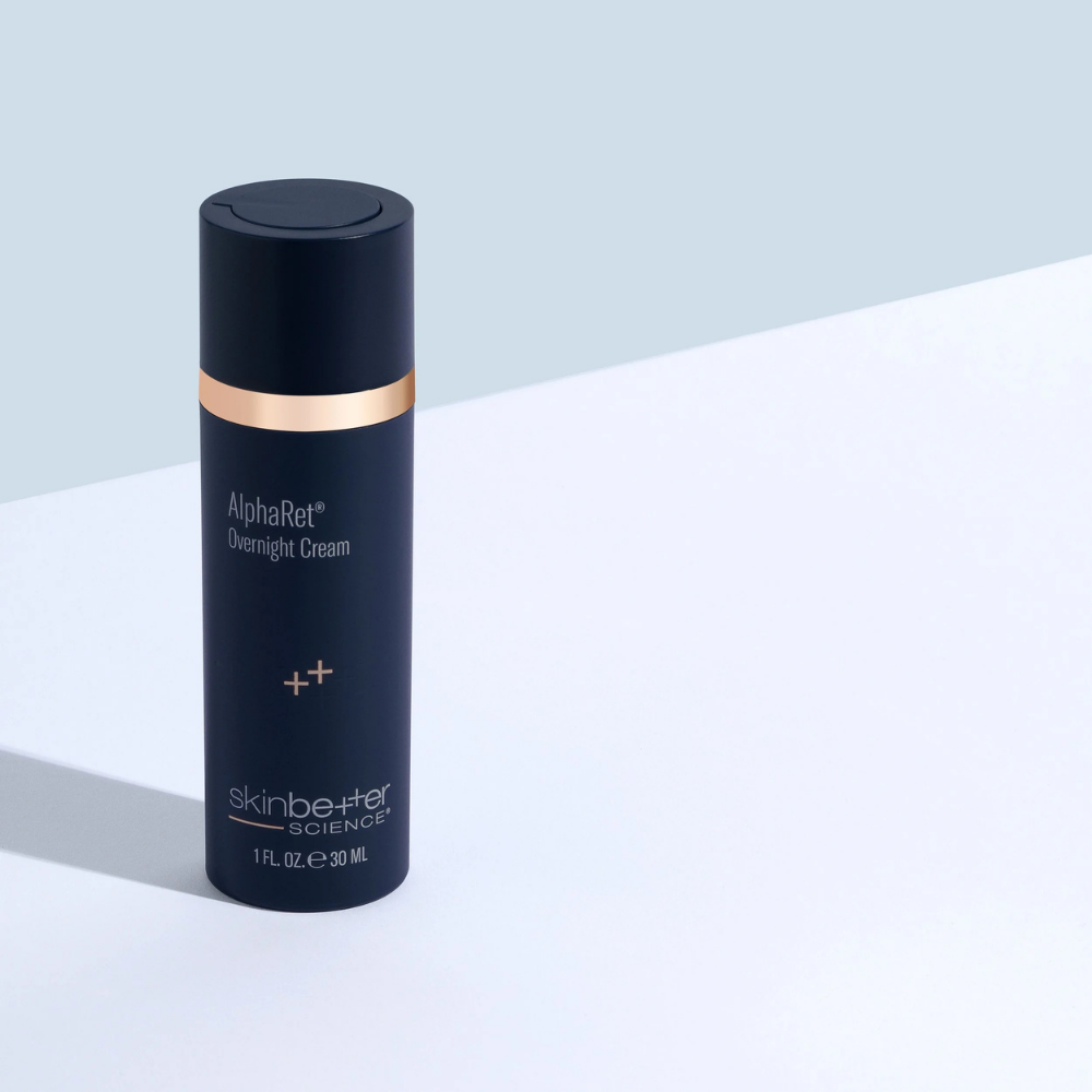 Skincare bottle labeled 'AlphaRet Overnight Cream' by skinbetter science on a light blue and white background