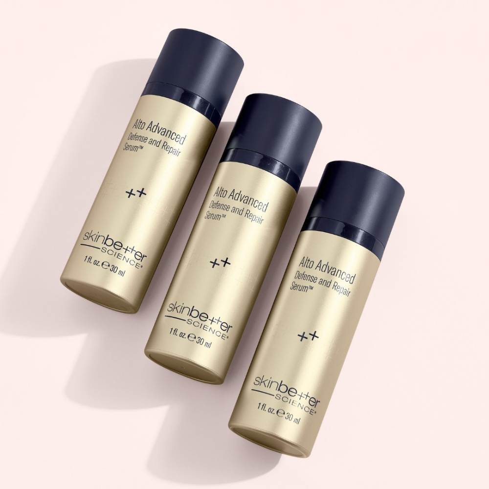 Three bottles of Skin Better Alto Advanced Defense and Repair Serum light pink background