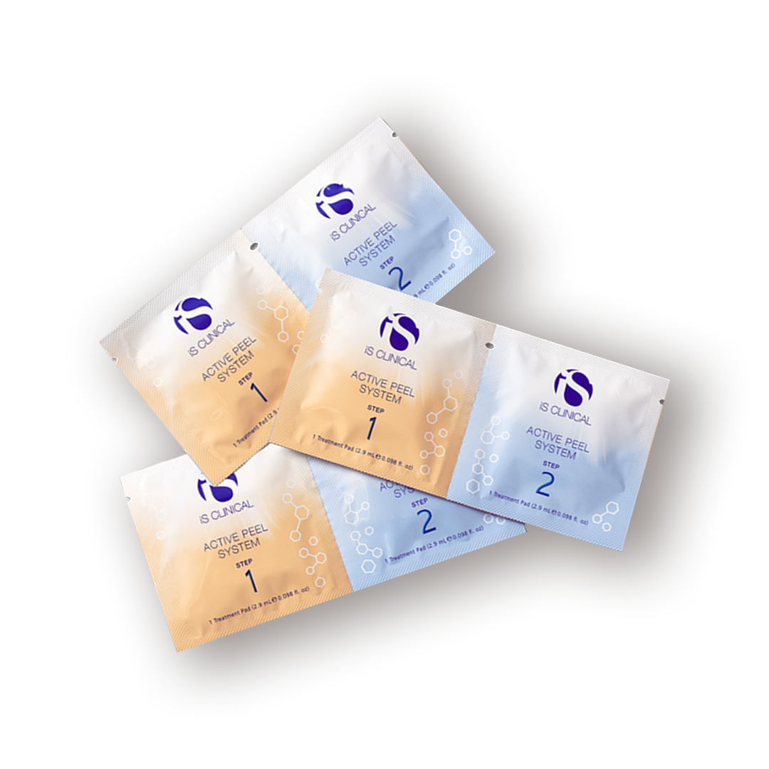 Multiple sachets of iS Clinical Active Peel System products arranged on a surface.