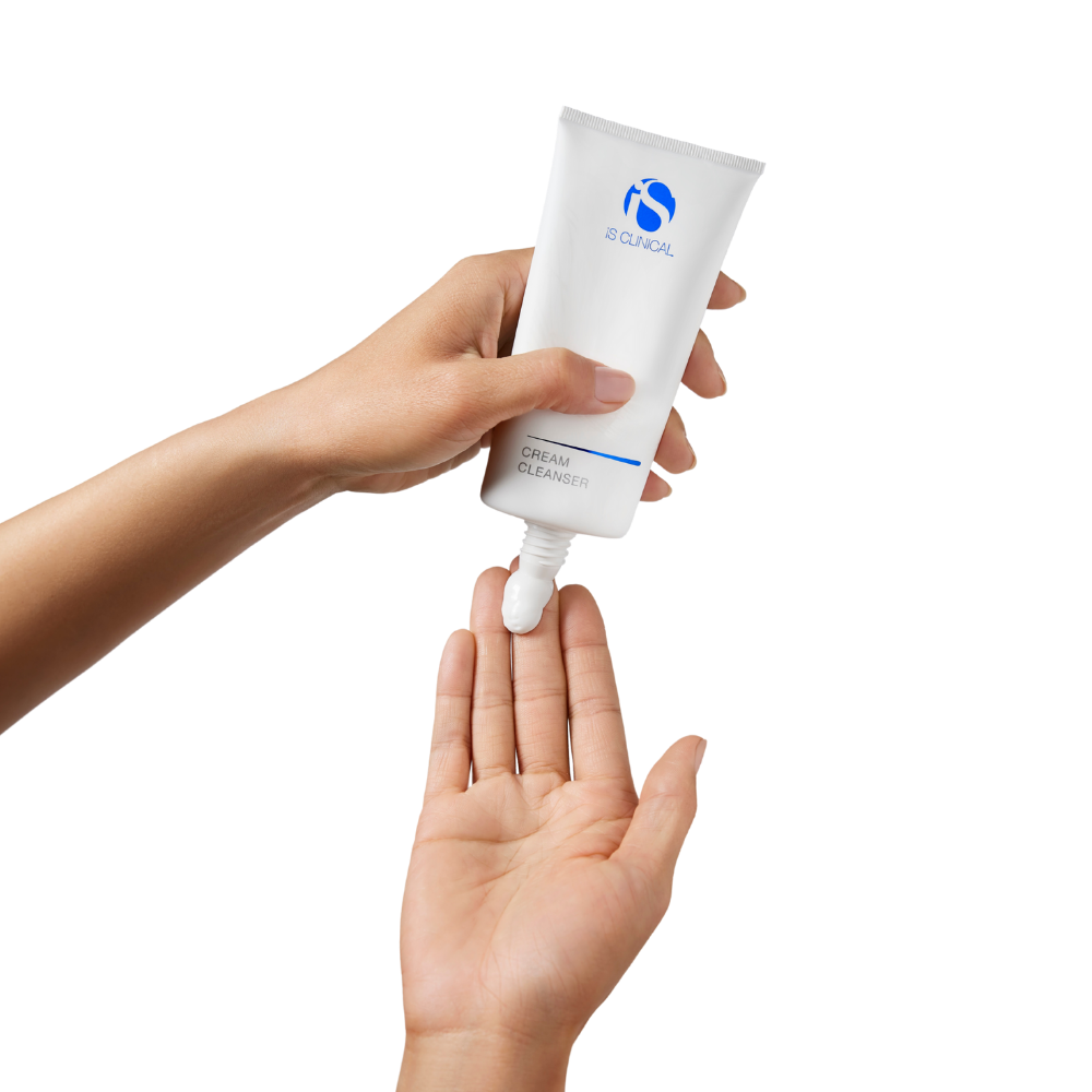 Hand applying iS Clinical Cream Cleanser to another hand