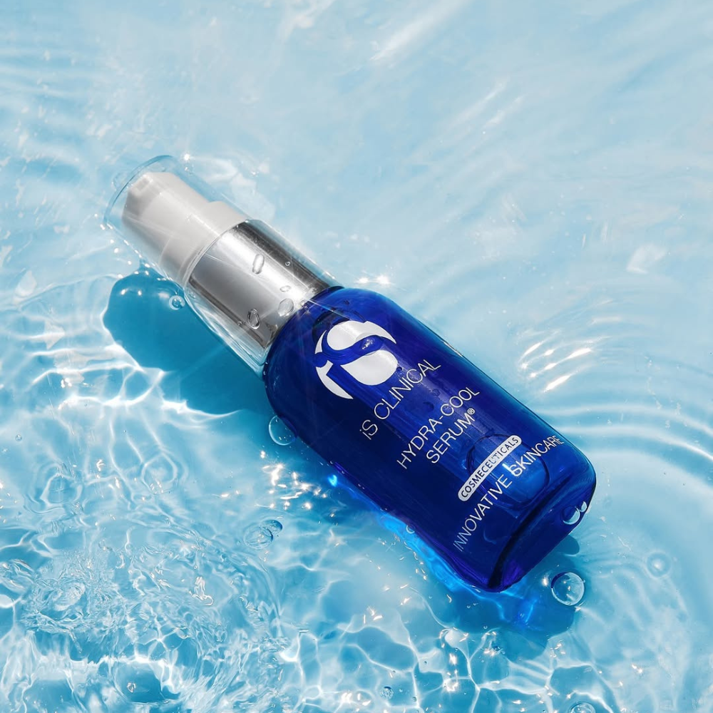 Blue serum bottle with silver pump of iS Clinical Hydra-Cool Serum on water surface