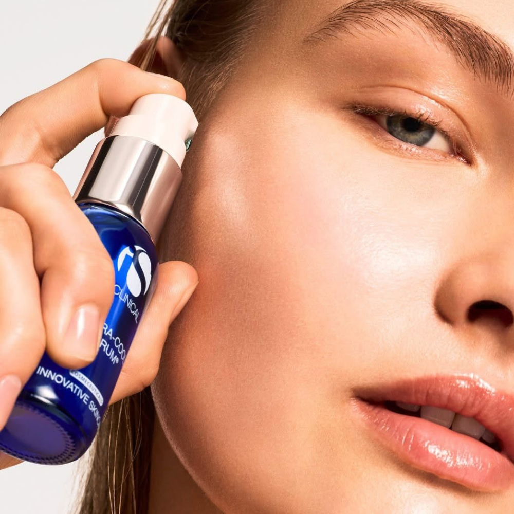 Person applying a iS Clinical Hydra-Cool Serum product to their face