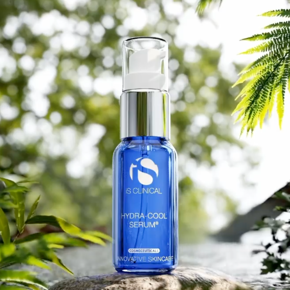 Blue serum bottle labeled 'IS Clinical Hydra Cool Serum' on a natural background with greenery.