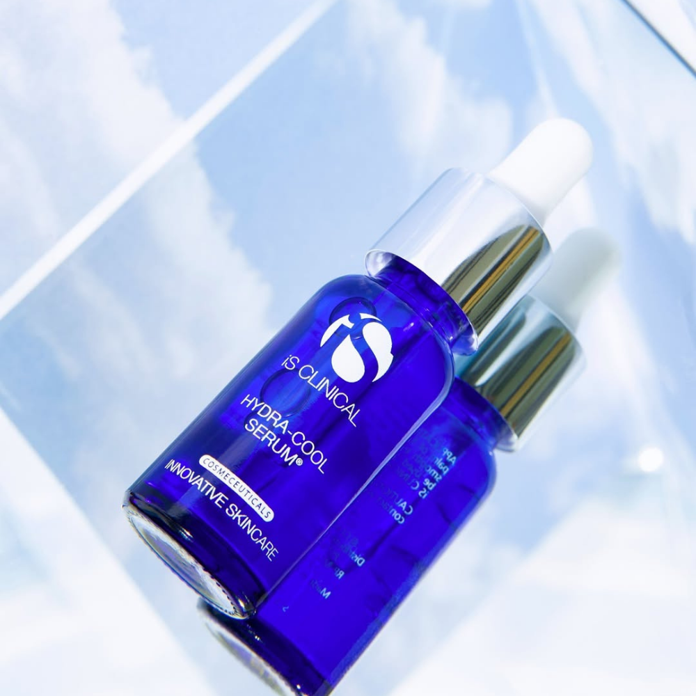 Blue skincare serum bottle with dropper of iS Clinical Hydra-Cool Serum on a light blue background