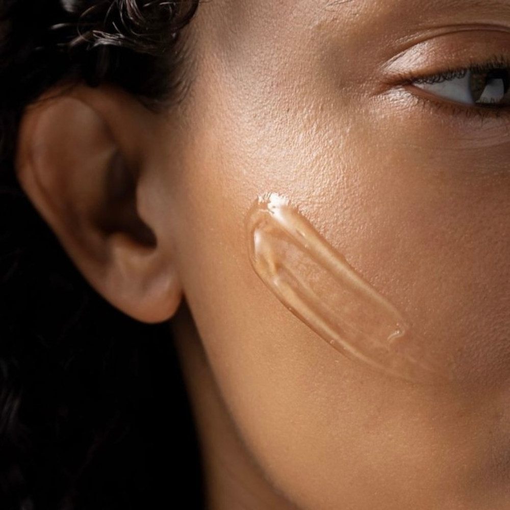 Close-up of a person's face with a cosmetic iS Clinical Hydra-Intensive Cooling Masque applied to the cheek