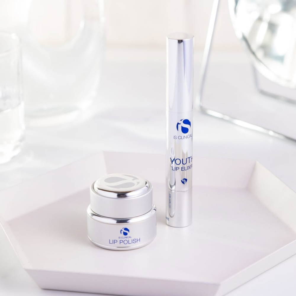 Lip Polish and Lip Elixir products on a white surface from the iS Clinical Lip Duo on a white tray with a white background