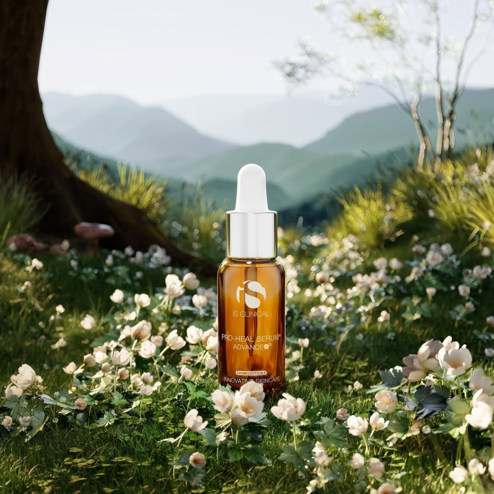 iS Clinical Pro-Heal Serum Advance+ bottle with white cap on grass and flowers