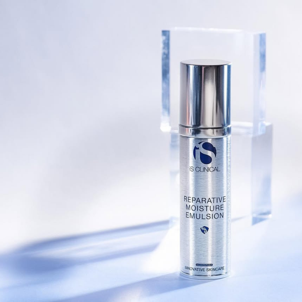 Skincare emulsion bottle labeled iS Clinical Reparative Moisture Emulsion on a light background