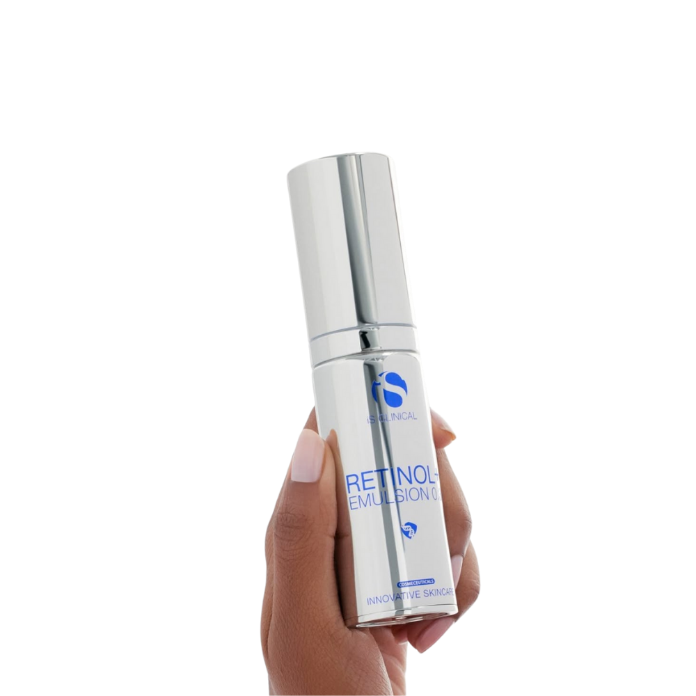 Hand holding a bottle of iS Clinical Retinol + Emulsion 0.3 facial serum