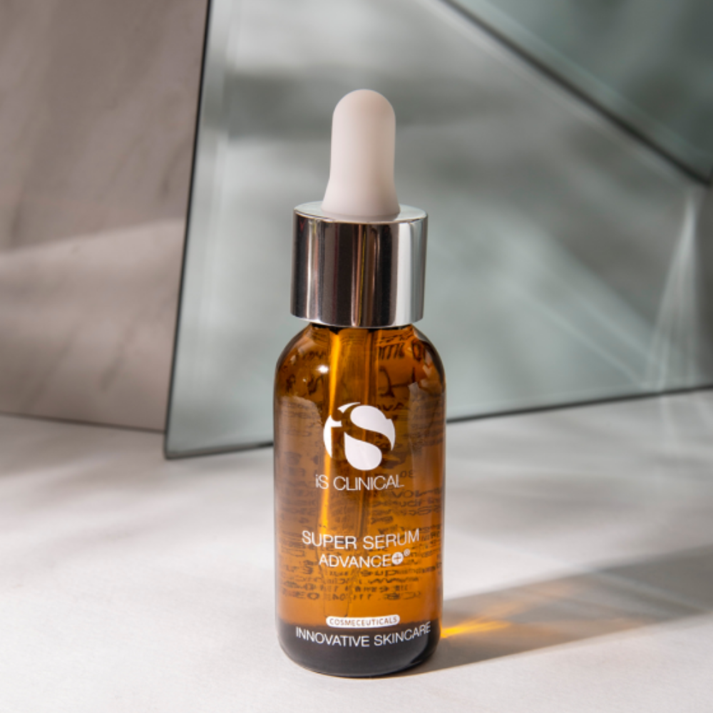 IS Clinical Super Serum Advance+ bottle with dropper on a neutral background