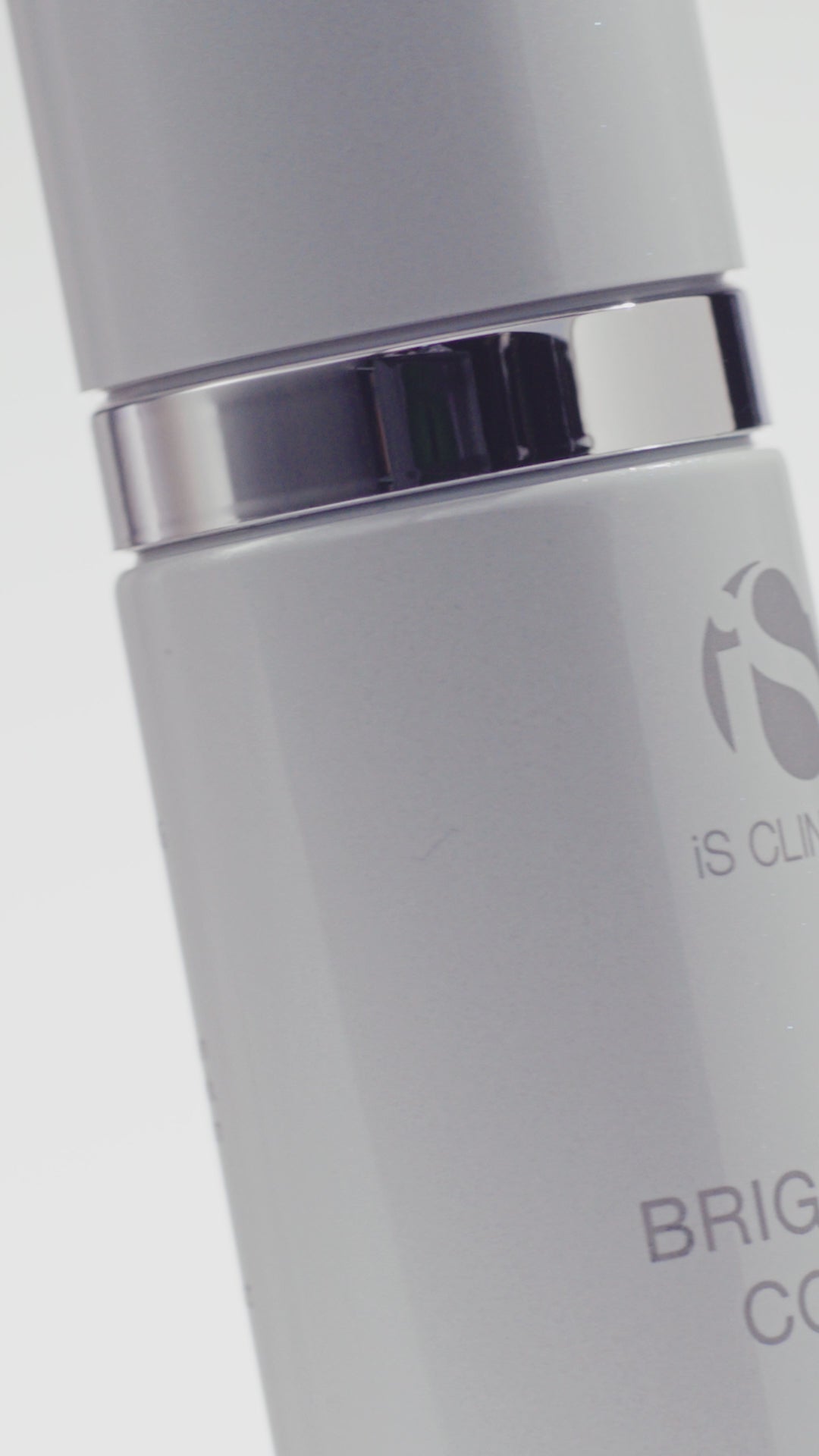 Video of white bottle of iS Clinical Brightening Complex being applied to the face by a moddle