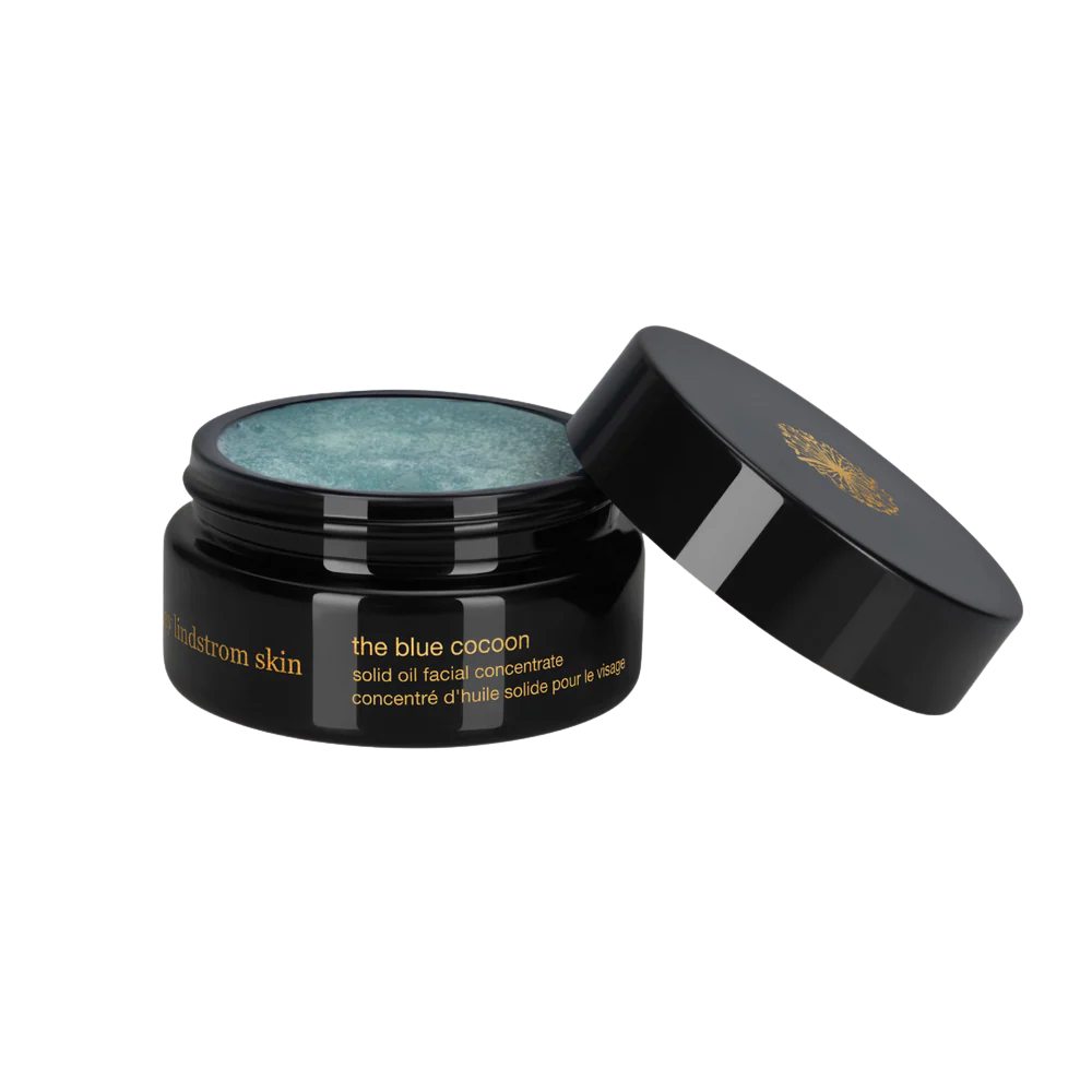 Black jar of May Lindstrom The Blue Cocoon solid oil facial concentrate with open lid 
