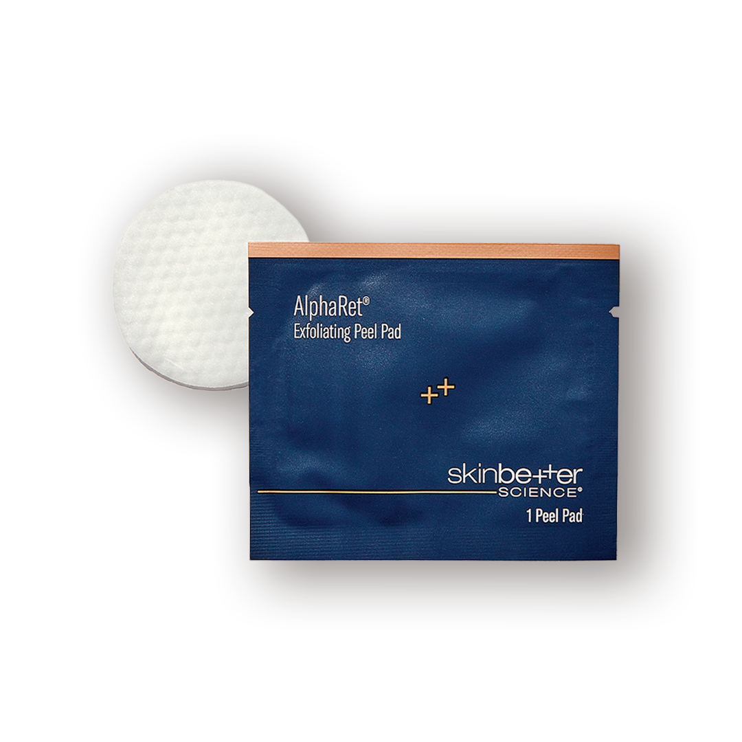 A package of SkinBetter AlphaRet Exfoliating Peel Pads with one white pad visible outside the package
