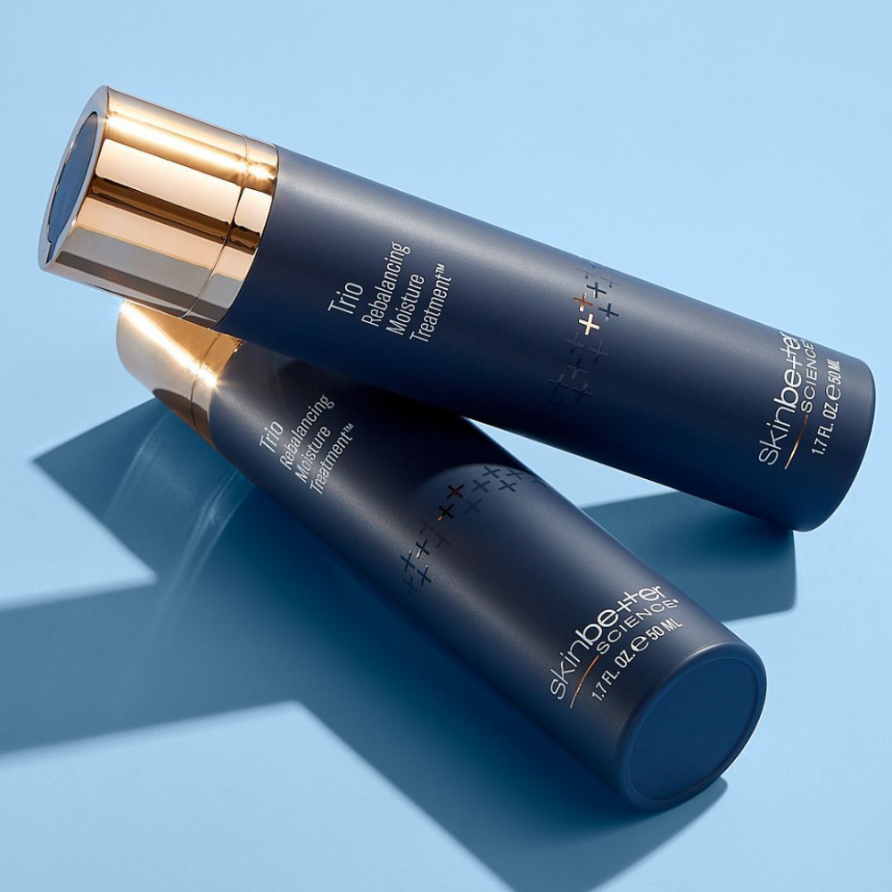 Two skincare bottles from the brand Skin Better Trio Rebalancing Moisturizer Treatment on a light blue background