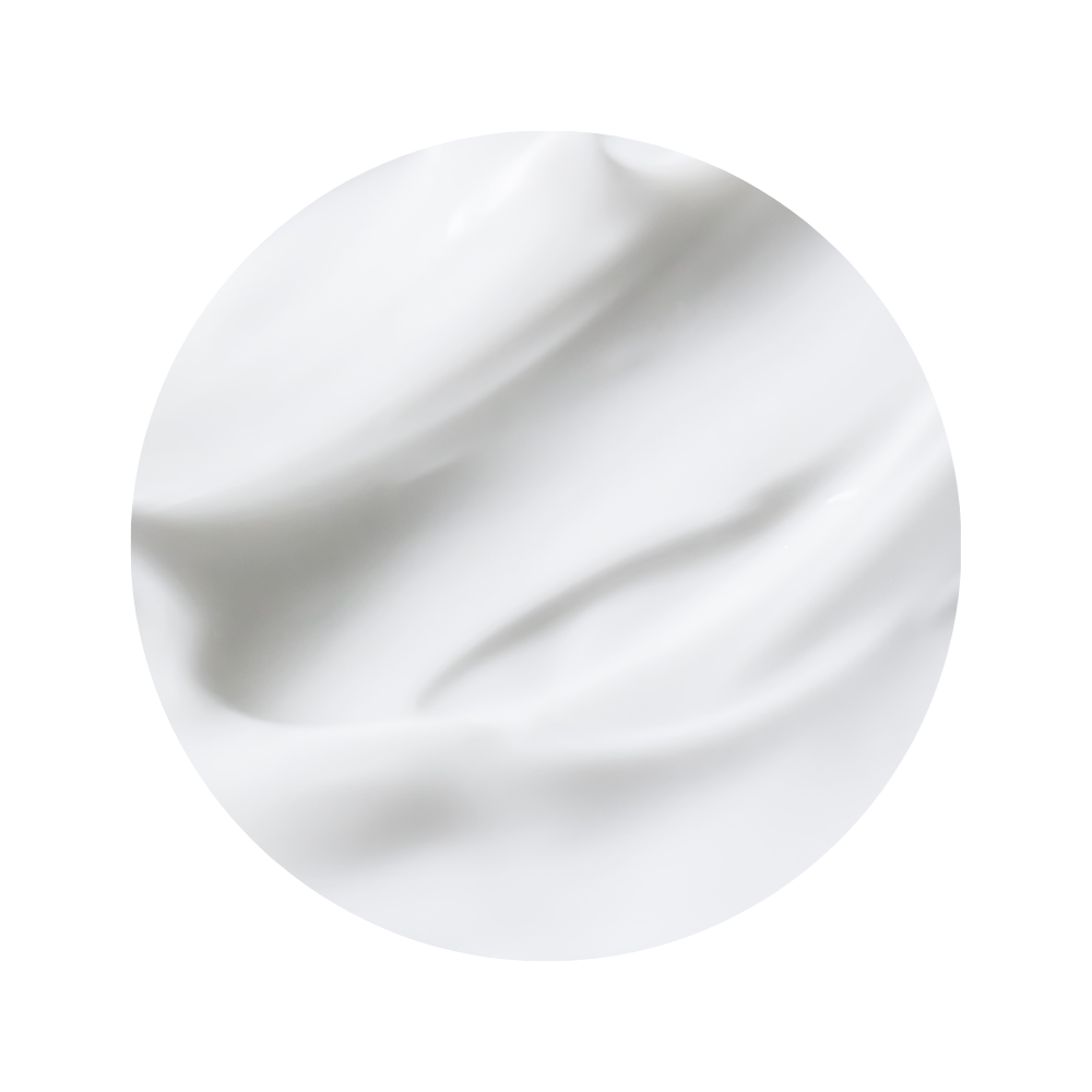 Close-up of smooth white skincare cream texture of iS Clinical Body Complex