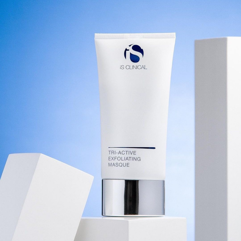 iS Clinical Tri-Active Exfoliating Masque on a light blue background